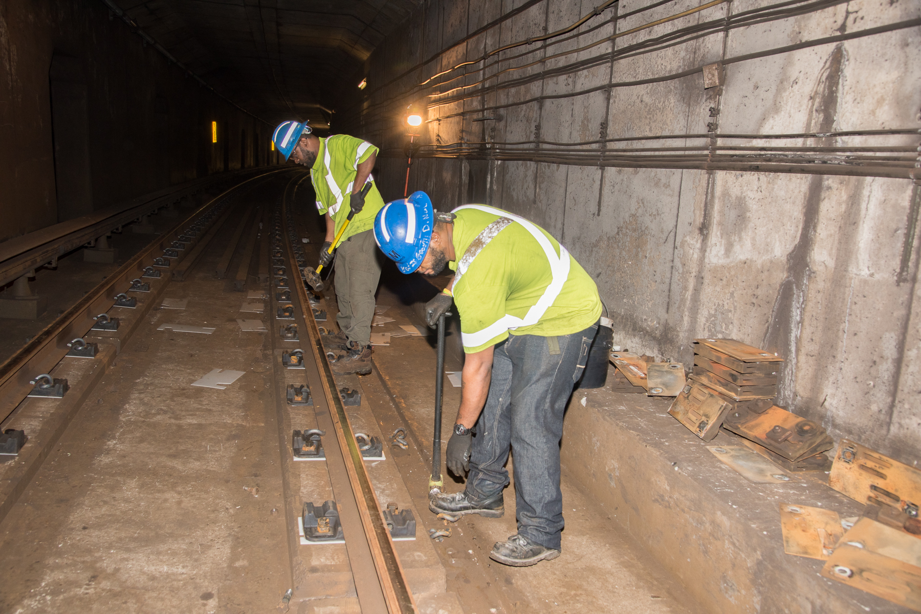 workers replacing rail fasteners